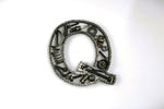 Load image into Gallery viewer, A letter Q made out of real car parts, outlined with a timing chain.
