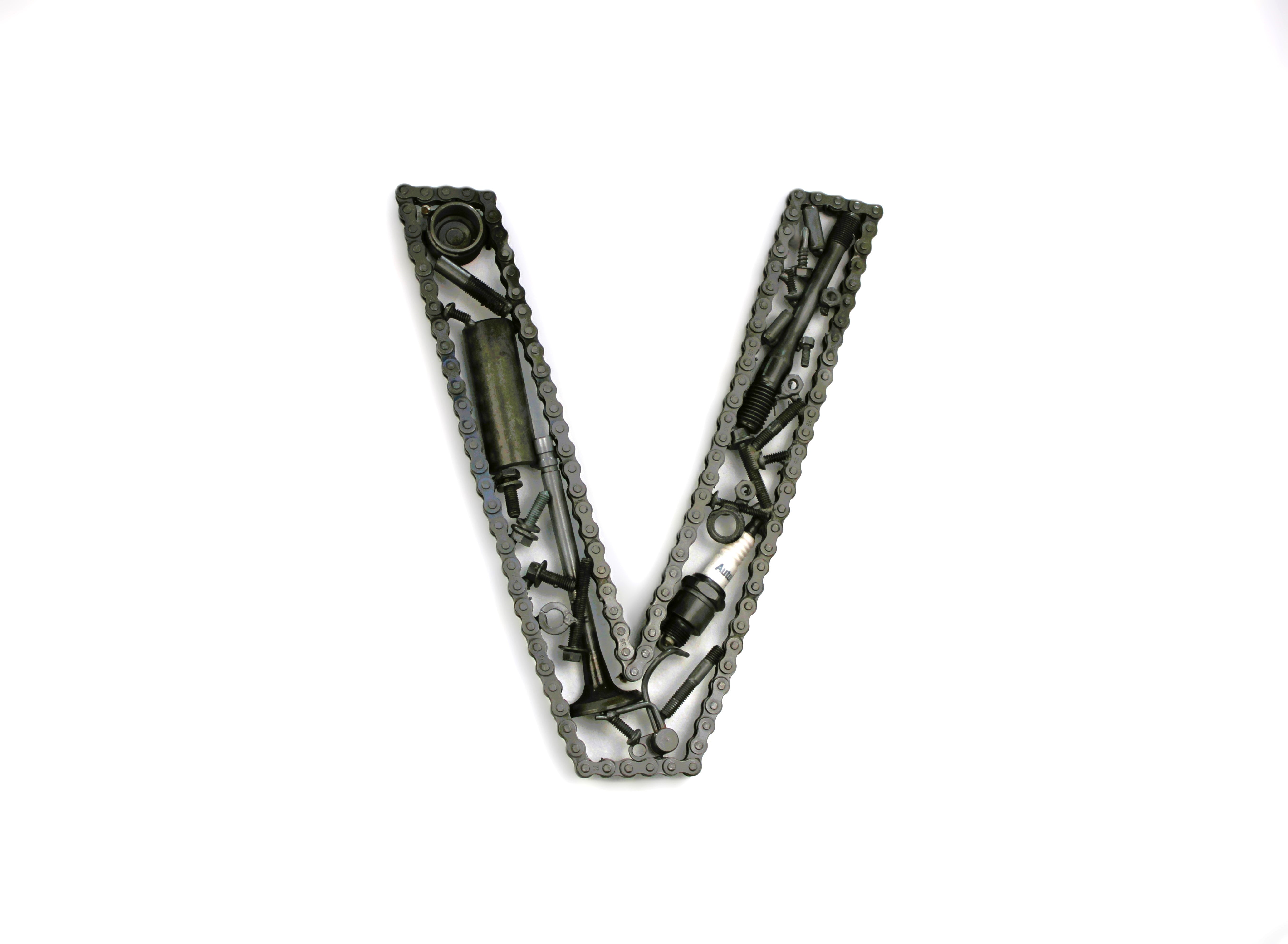 A letter V made out of real car parts, outlined with a timing chain.