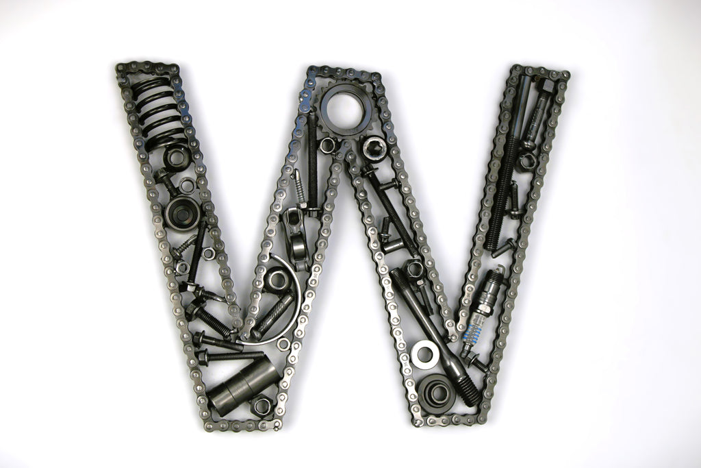 A letter W made out of real car parts, outlined with a timing chain.