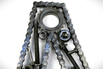 Load image into Gallery viewer, Close-up view of a letter W made out of real car parts, outlined with a timing chain.
