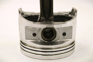 Close-up view of the base of a polished car piston clock.