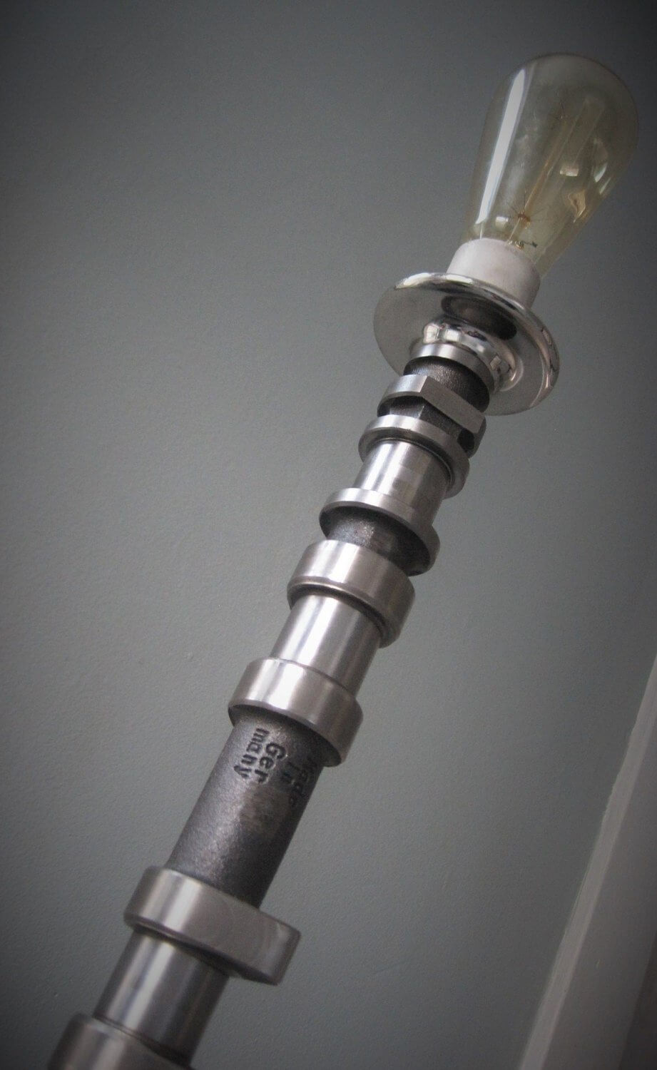 Tabletop lamp handcrafted from a genuine polished car engine camshaft with a LED lightbulb.
