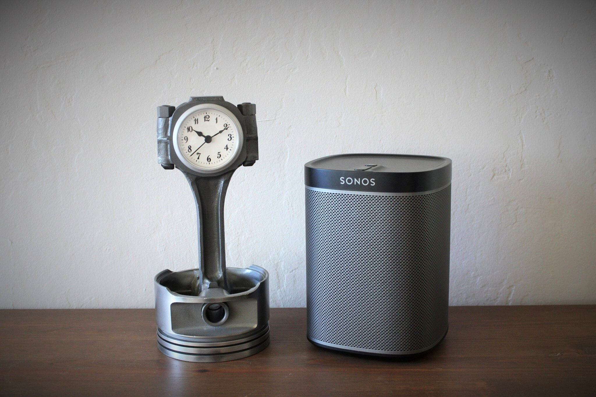 Tabletop clock handcrafted from a genuine Chevrolet car engine piston with various colored finishes and a standard clock face.