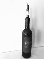 Load image into Gallery viewer, A bottle stopper made from a car&#39;s spark plug in use inside of a wine bottle.
