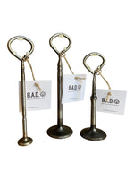 Load image into Gallery viewer, Three bottle openers made out of car engine valves with tags reading, &quot;B.A.D., Ben&#39;s Automotive Decor&quot;
