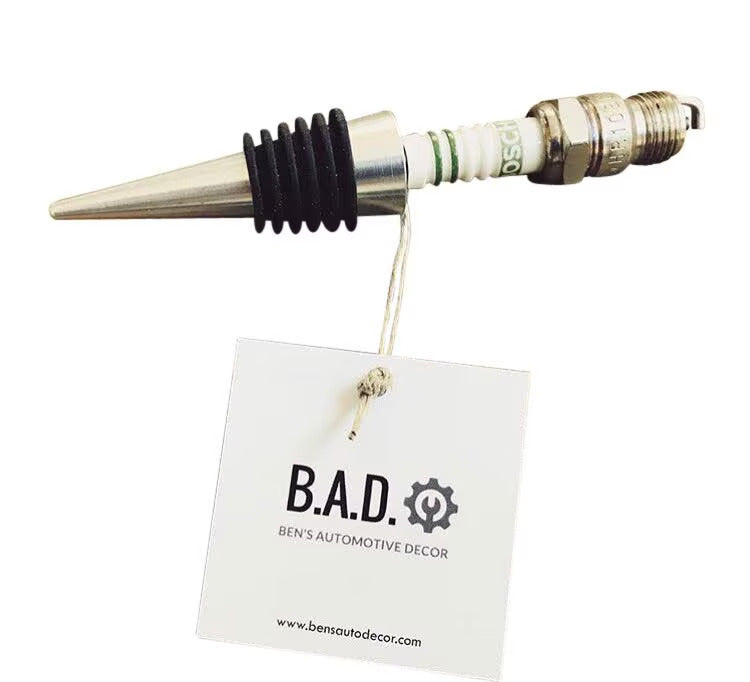 Bottle stopper made from a car's spark plug with a tag reading, "B.A.D., Ben's Automotive Decor"