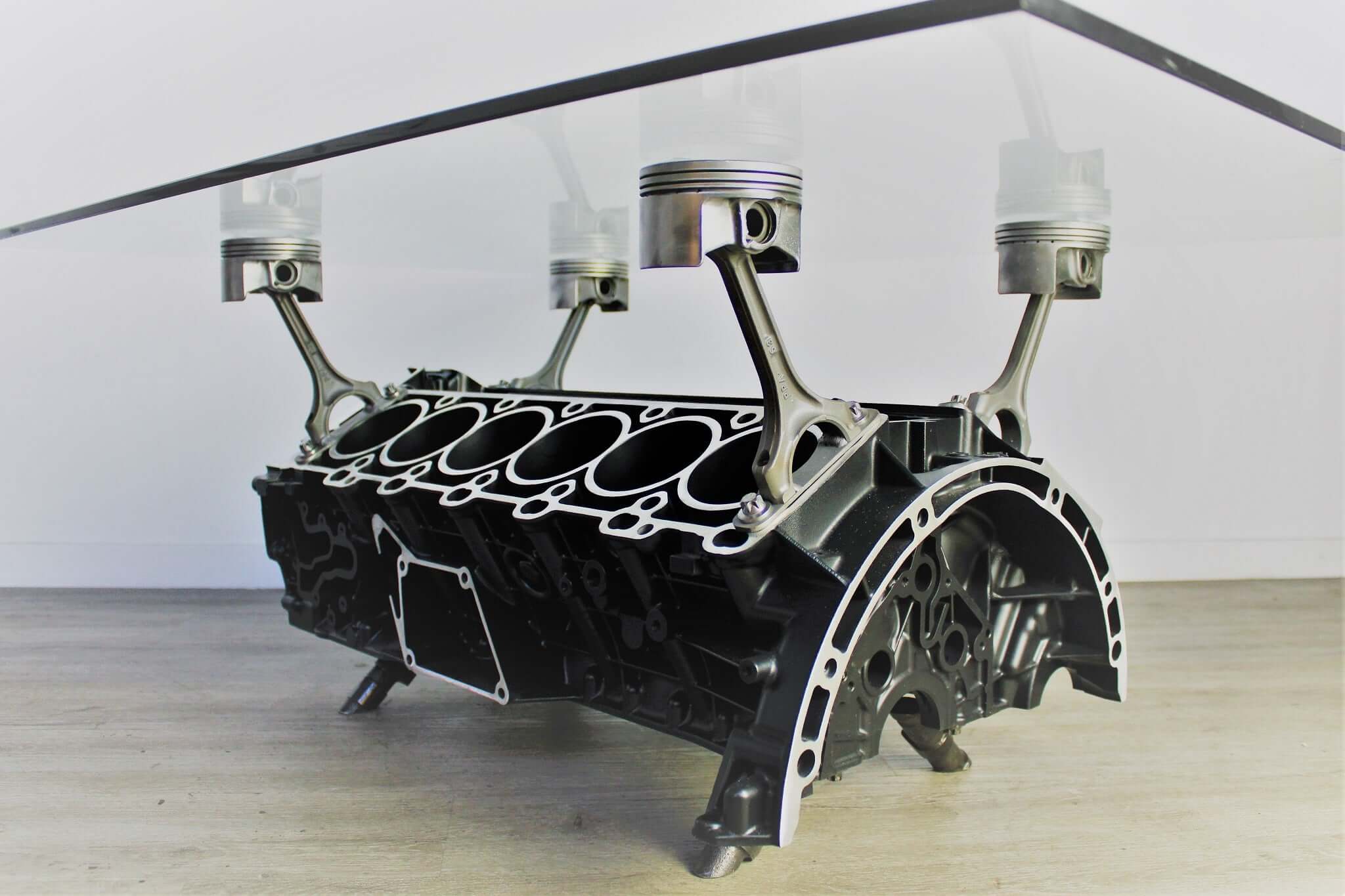 Coffee table handcrafted from a genuine Mercedes V12 car engine, finished in black and silver with the Mercedes-Benz logo displayed and a rectangular glass top.