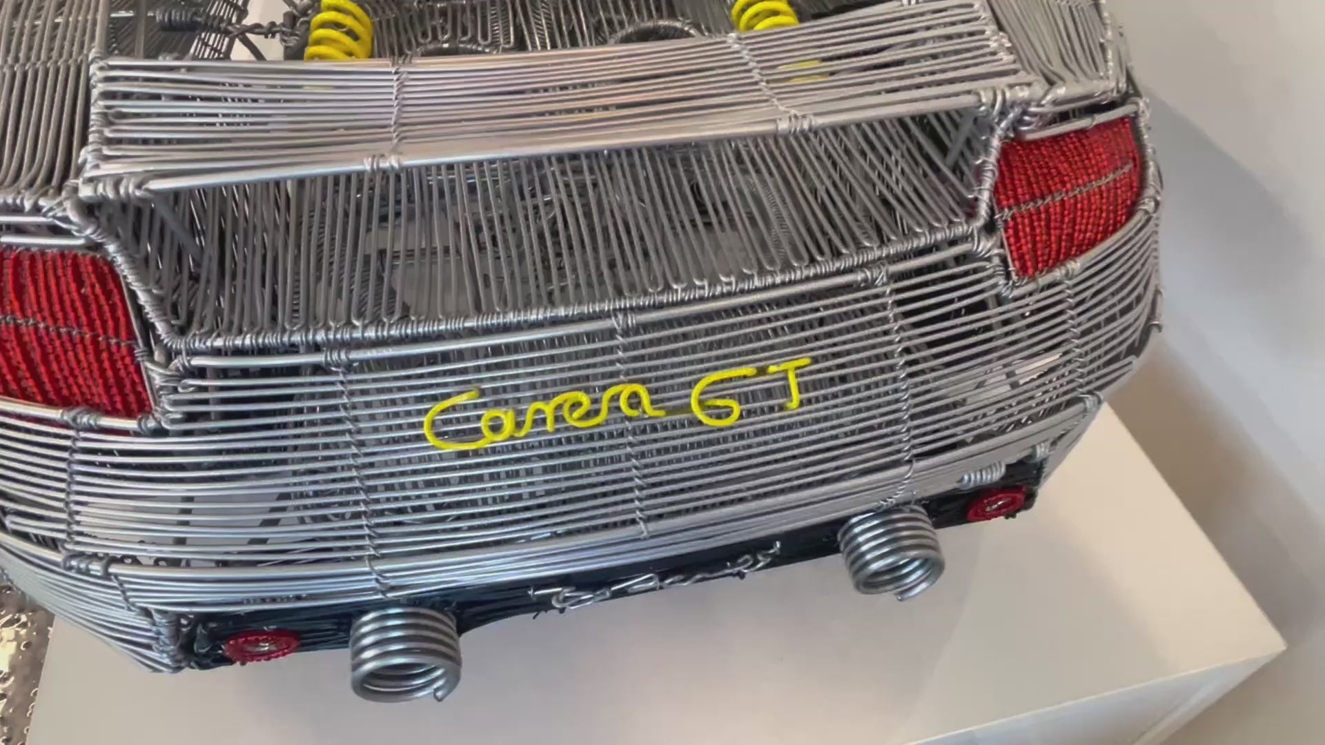 Video of a model of a Porsche Carrera GT car made entirely out of wire.
