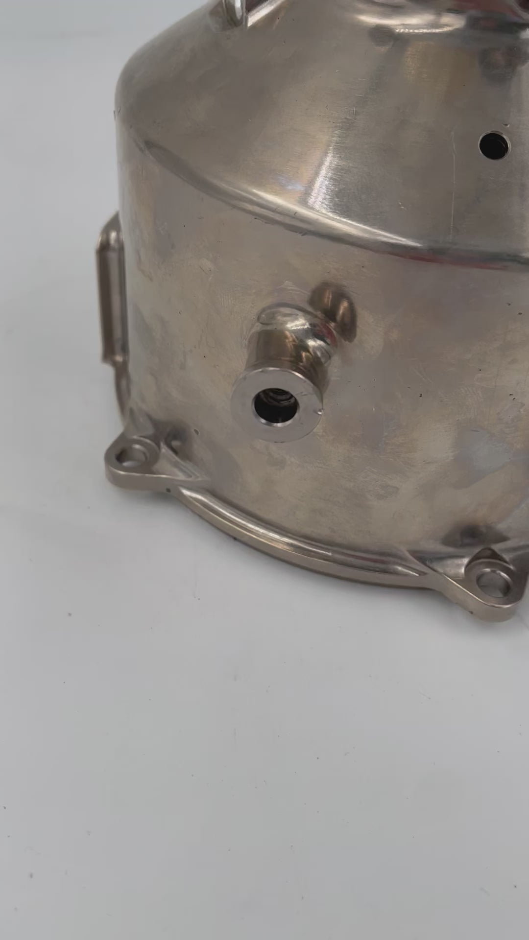 Video of a lamp with no shade made from a McLaren car's clutch housing in a shiny finish.