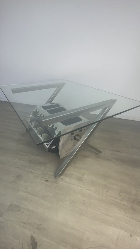 Video of a Top Fuel aluminum engine block coffee table finished in black and silver with a rectangular glass top.