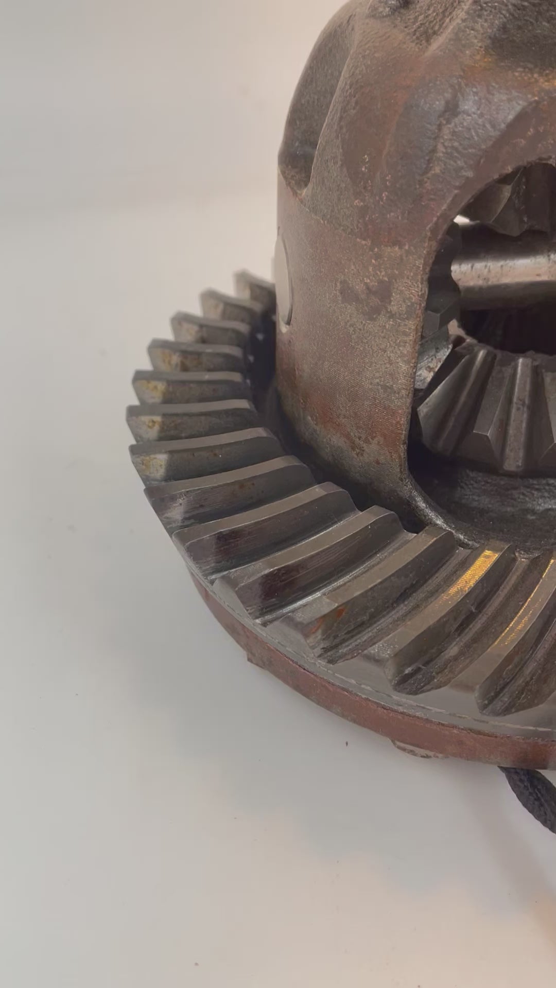 A video showcasing a lamp made out of a car's rear differential, without its shade and turned on.