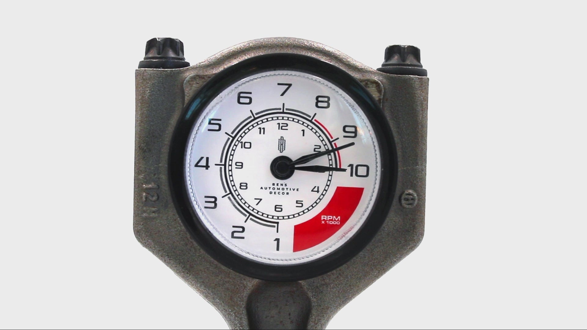 Video of a clock ticking that was made from a car piston with a custom RPM clock face.