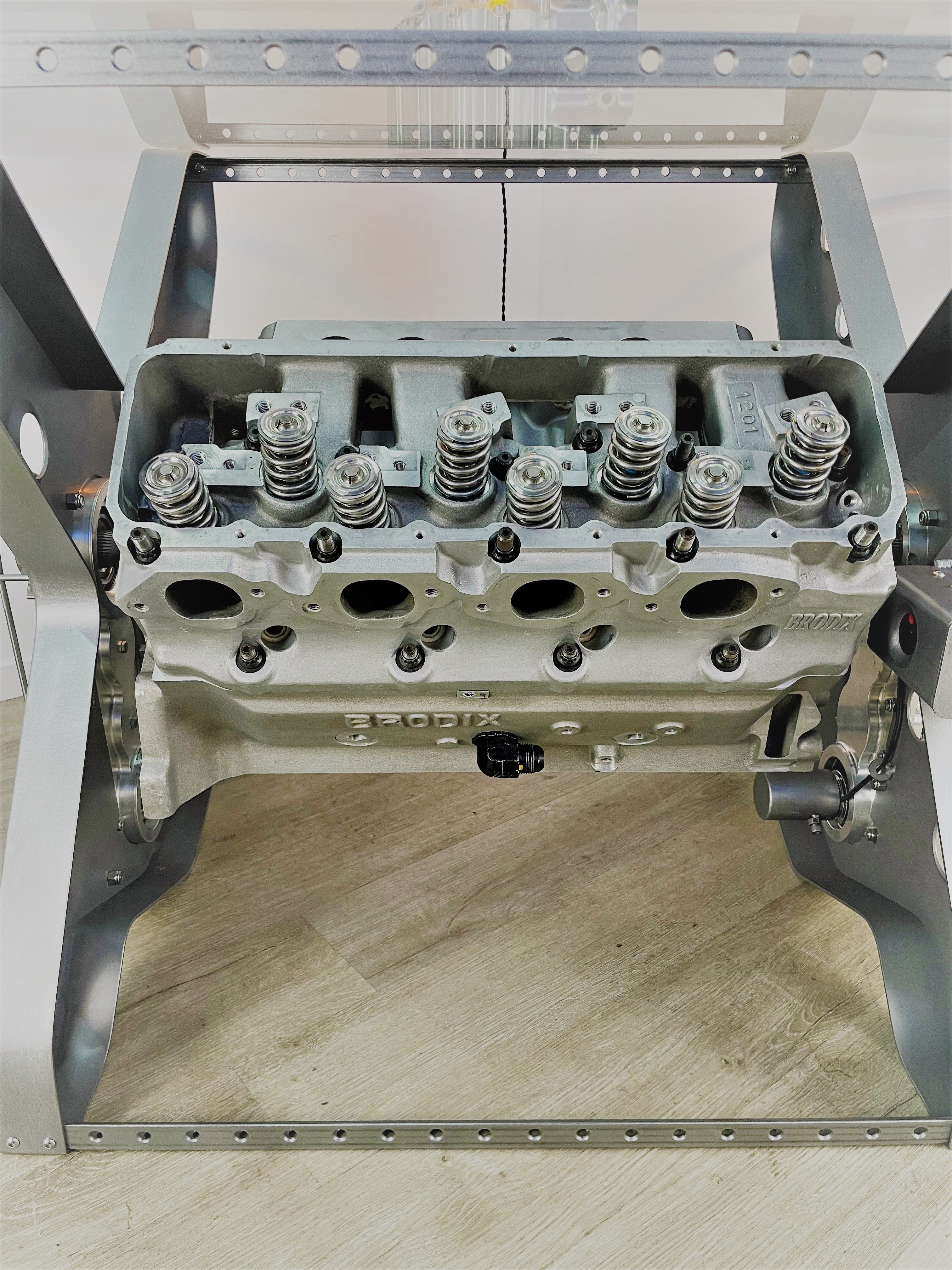 Close-up view of the rotating engine within an X-frame dining table.