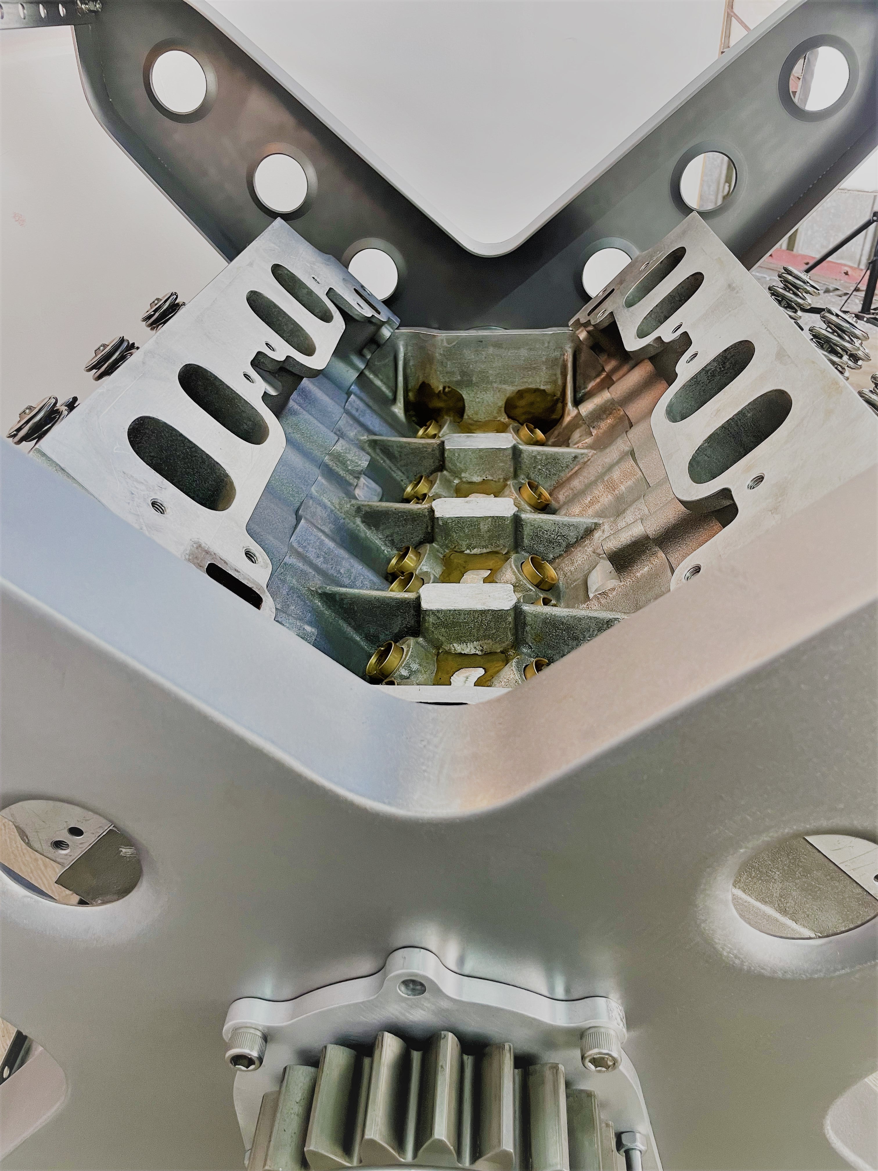 Close-up view of the rotating engine within a X-frame dining table.