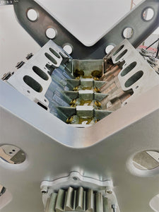 Close-up view of the rotating engine within a X-frame dining table.