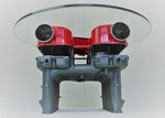 Load image into Gallery viewer, Lower view of a Ferrari intake manifold table, finished in red and gunmetal gray with a round glass top.
