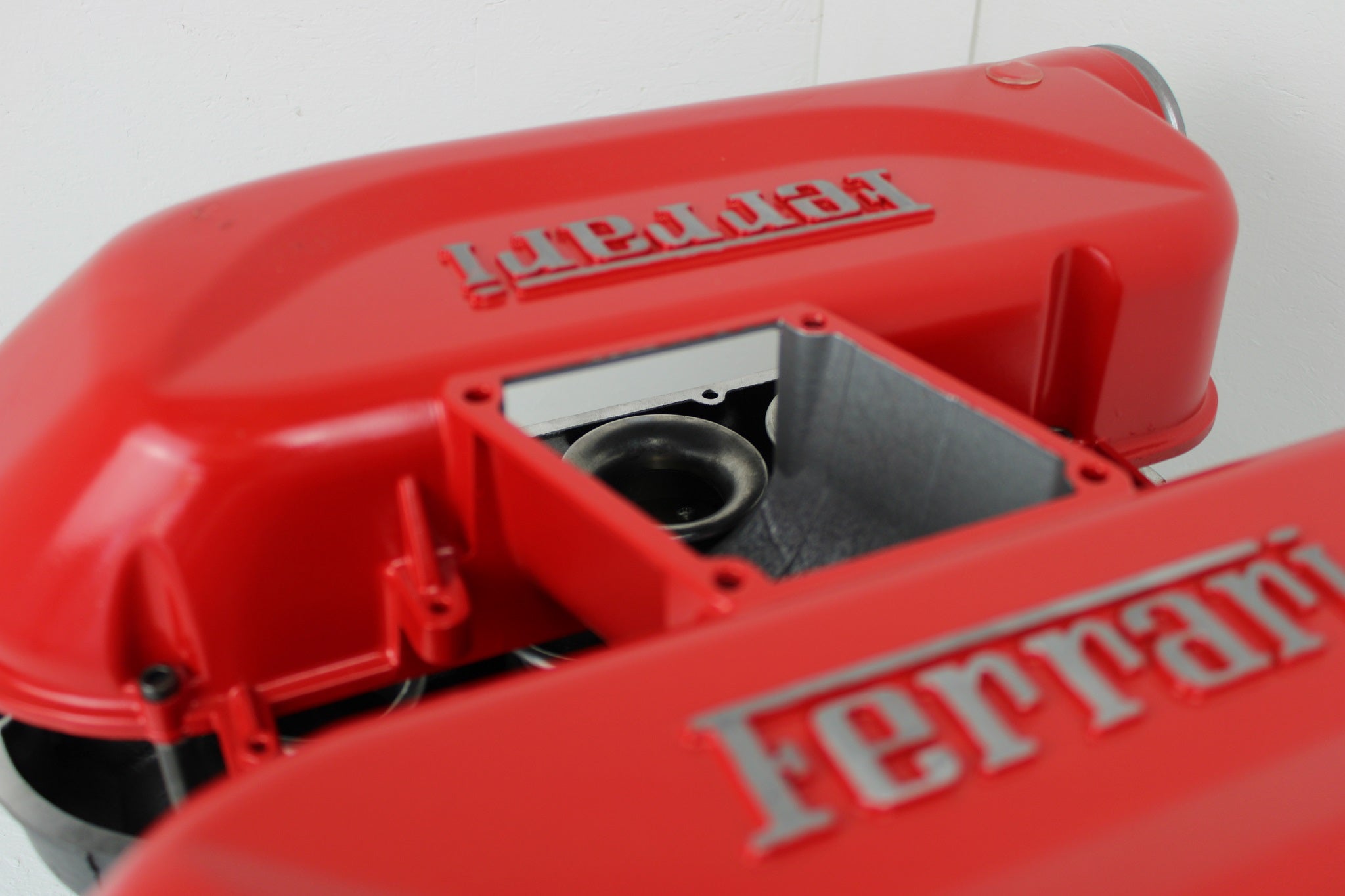 Close-up view of a Ferrari intake manifold coffee table without its glass top.