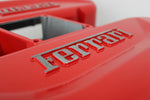 Load image into Gallery viewer, Close-up view of a Ferrari intake manifold table finished in red with the Ferrari logo displayed.

