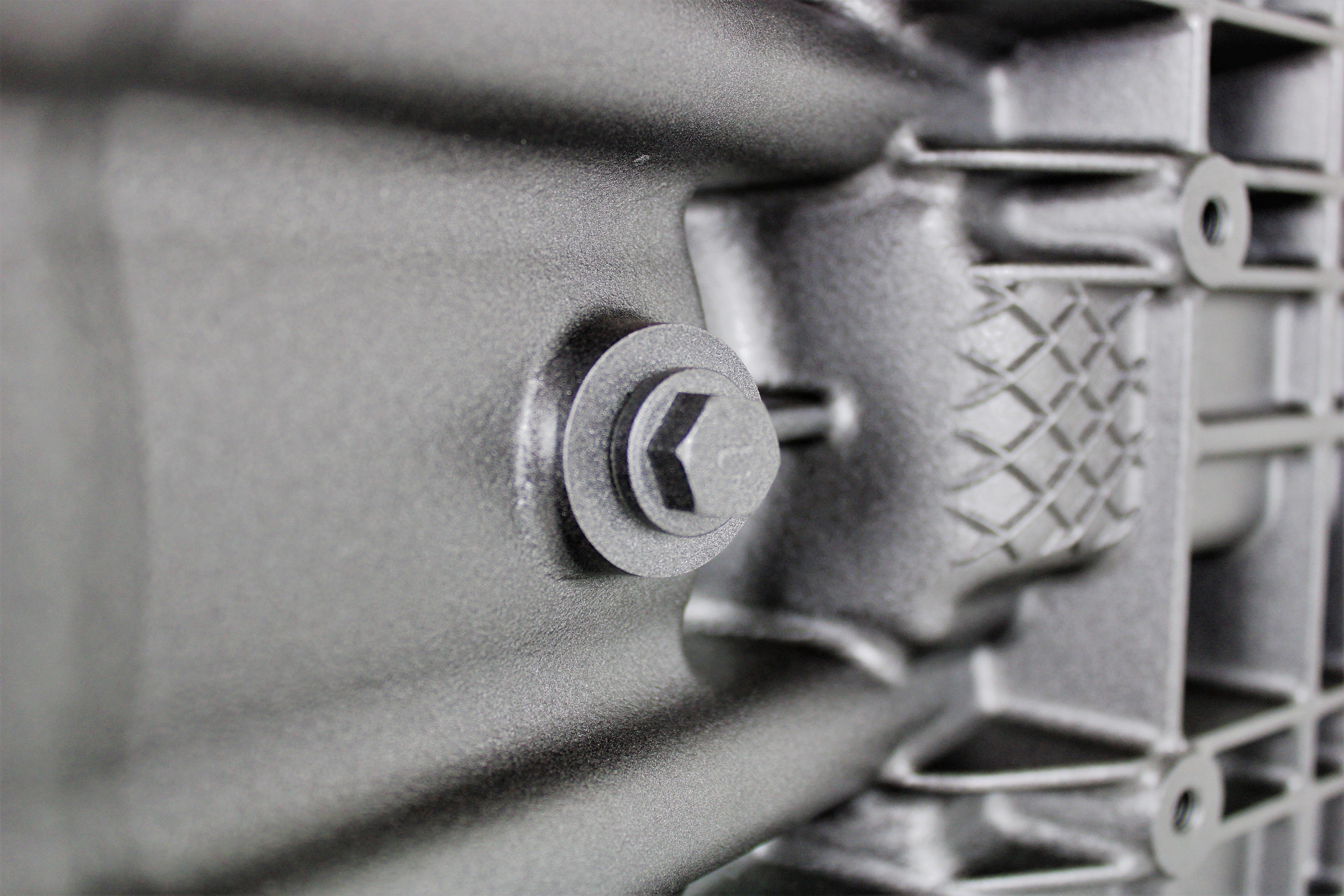 Close-up of a BMW end table and wine rack finished in gunmetal grey.