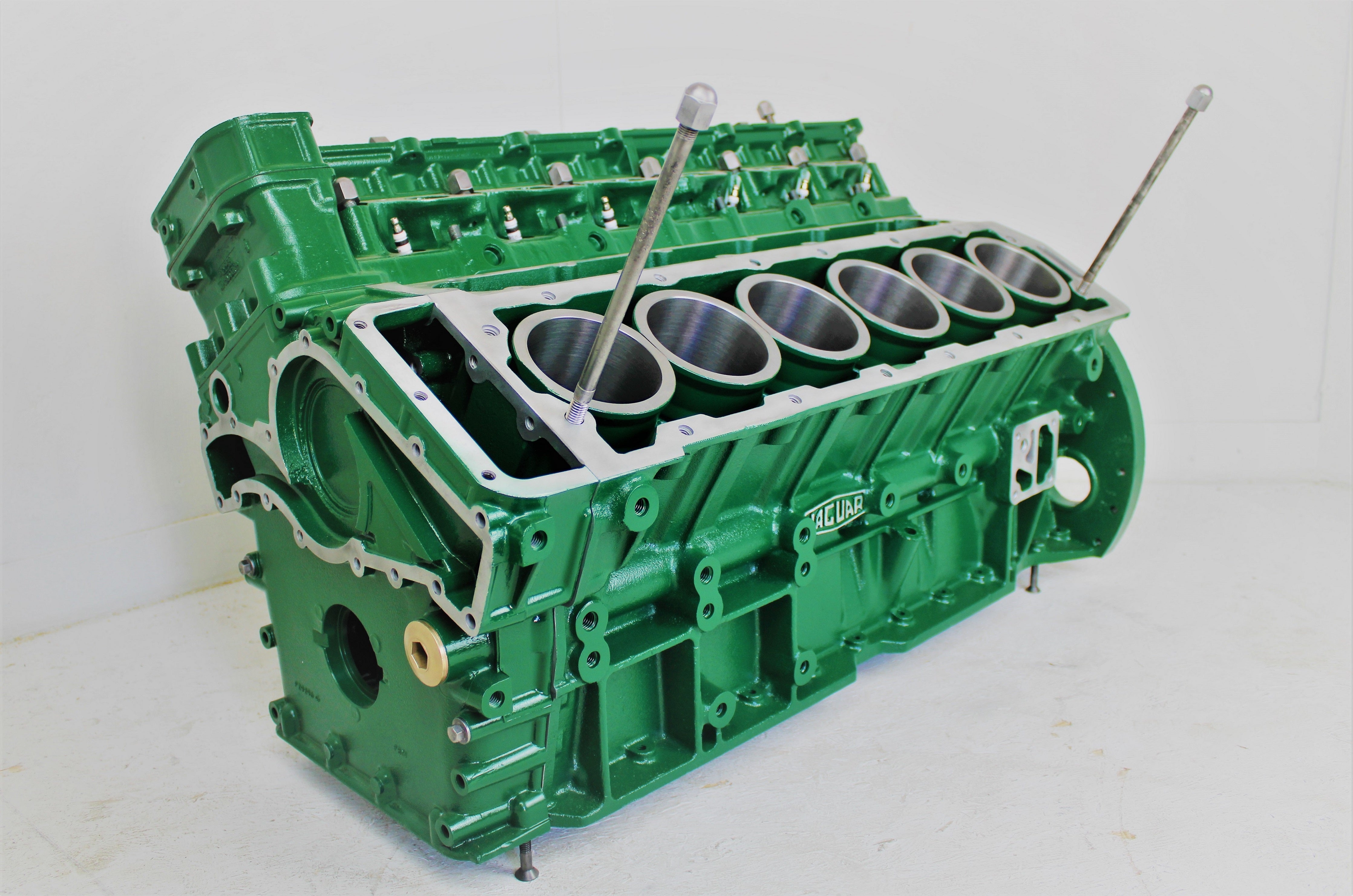 Jaguar V12 engine block coffee table, finished in British Racing Green without its glass top, the Jaguar logo displayed in the center.