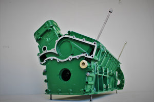 Side view of a Jaguar V12 engine block coffee table, finished in British Racing Green without its glass top.