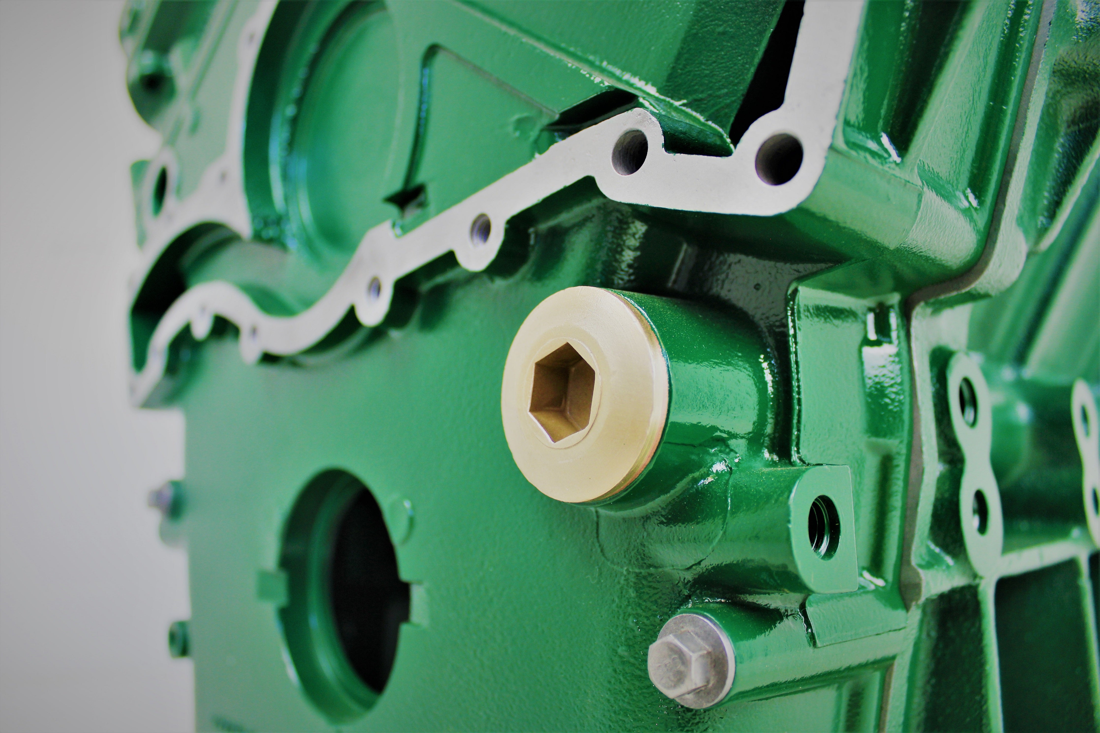 Close-up view of a Jaguar V12 engine block coffee table, finished in British Racing Green.