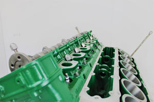 Close-up view of a Jaguar V12 engine block coffee table, finished in British Racing Green without its glass top.