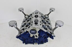 Bentley engine block coffee table without its glass top. The table is painted dark blue, with the Bentley logo displayed on the front.