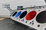 Load image into Gallery viewer, A close-up side view of a BMW M Series V10 engine block coffee table painted in the BMW M-Power color scheme without its glass top.
