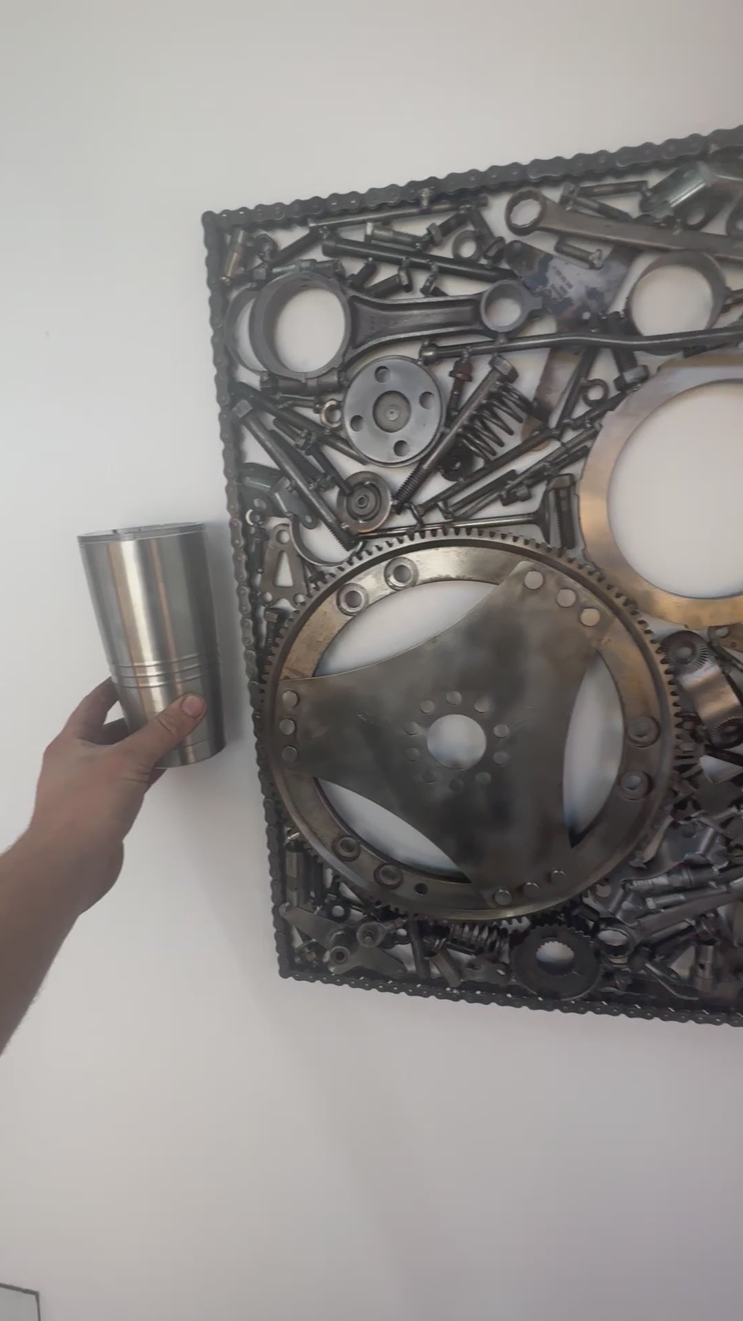 Video of a 24 by 24 inch wall hanging automotive wall art piece, made out of real car parts