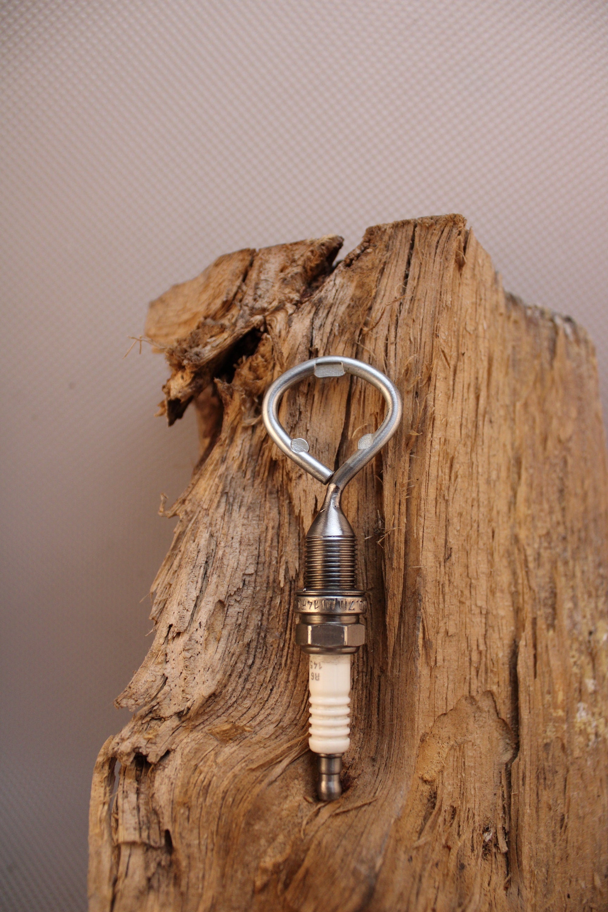 Bottle opener made from a car's spark plug.