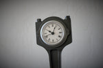 Load image into Gallery viewer, Close-up view of a piston clock made out of a Jaguar car&#39;s piston, finished in gunmetal gray with a silver clock ring.
