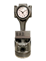 Load image into Gallery viewer, A piston clock finished in gunmetal gray with a black clock ring that includes a custom engraved plaque that reads, &quot;B.A.D, Ben&#39;s Automotive Decor&quot;.
