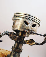 Load image into Gallery viewer, Piston man car part sculpture holding a wrench.
