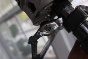 Close-up view of a piston man car part sculpture.
