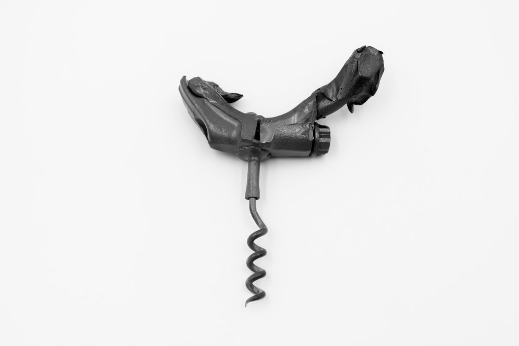 Bottle opener made out of a connecting rod corkscrew from a blown car engine.