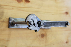Wrench and nut toilet paper holder, finished in silver.