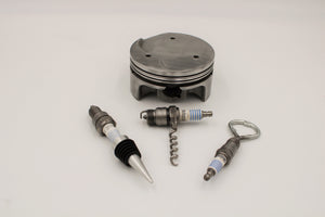 Spark plug bar set including a wine stopper, corkscrew and bottle opener, all made from car spark plugs with a car piston holder.